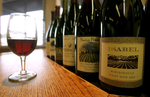 A glass of Hartley Ostini 2002 Hitching Post Santa Barbara County Pinot Noir is photographed with bottles of Pinot Noir wines (the most favorite of the Sideways movie) at The San Francisco Wine Trading Company in San Francisco, February 18, 2005.